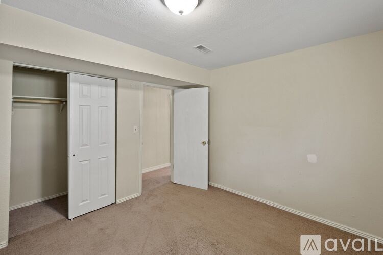 A room with two white doors and a carpeted floor.