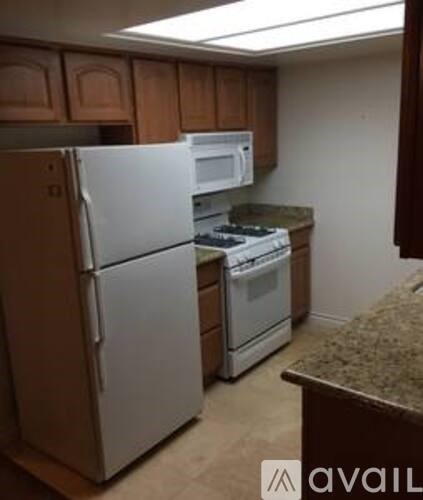 A kitchen with a white refrigerator and stove.