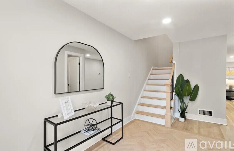 A black and white console table with a mirror above it.