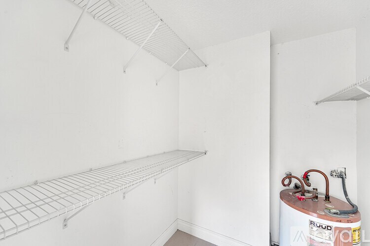 A room with a white wall and a gas tank.