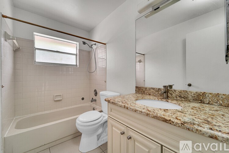 A bathroom with a marble countertop and a white toilet.
