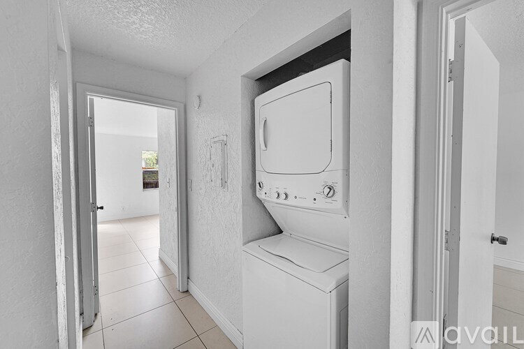 A white oven in a kitchen with a door open.