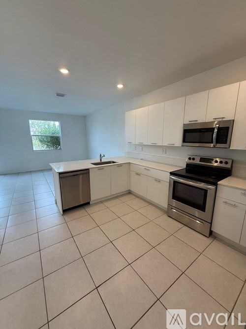 A kitchen with white cabinets and a stainless steel oven.