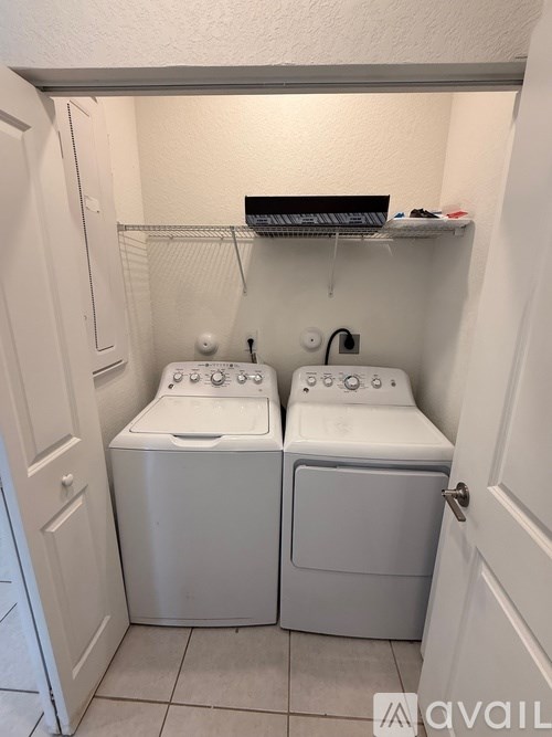 A small laundry room with a washer and dryer.