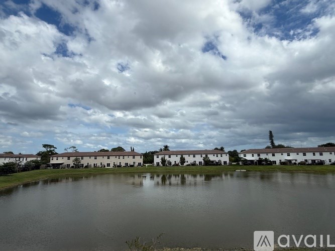 A body of water in front of a row of houses.