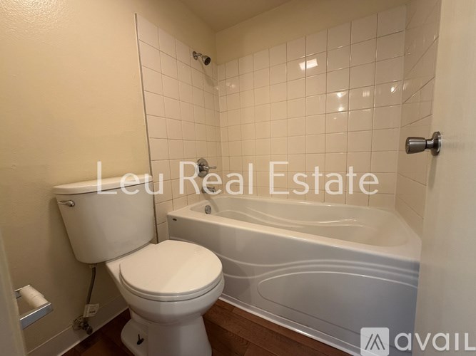 A white toilet and bathtub in a bathroom.