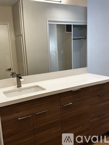 A bathroom with a sink and a mirror.