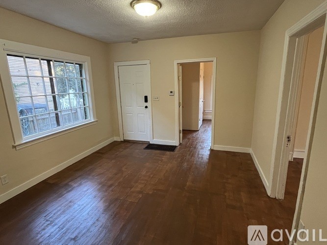 A room with wooden floors and white walls.