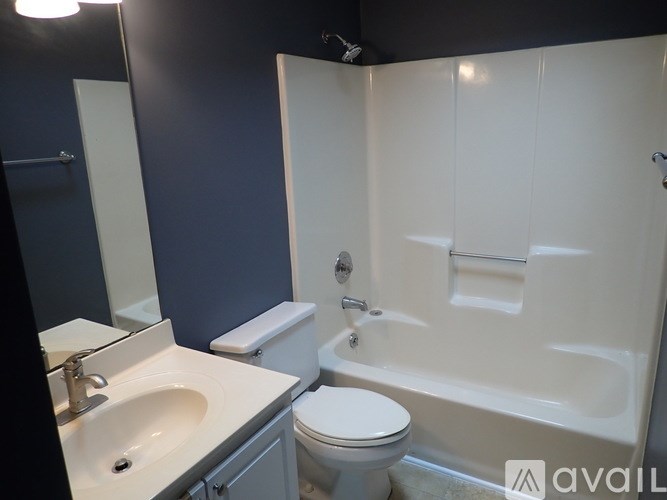 A bathroom with a toilet, sink, and bathtub.