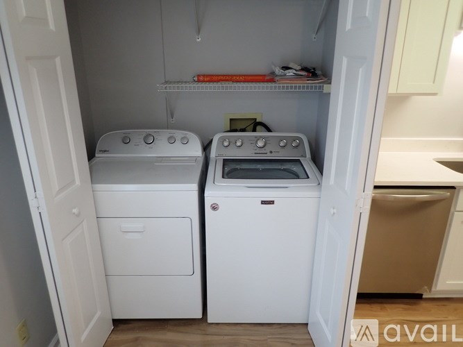 A small laundry room with a washer and dryer.