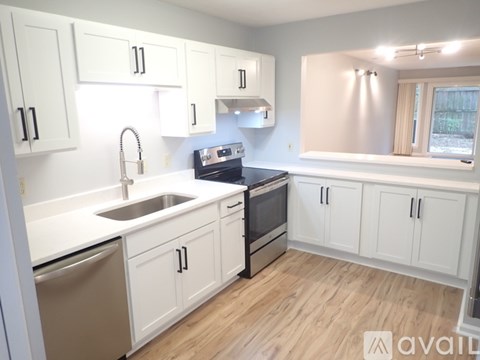 A kitchen with white cabinets and a stainless steel dishwasher.