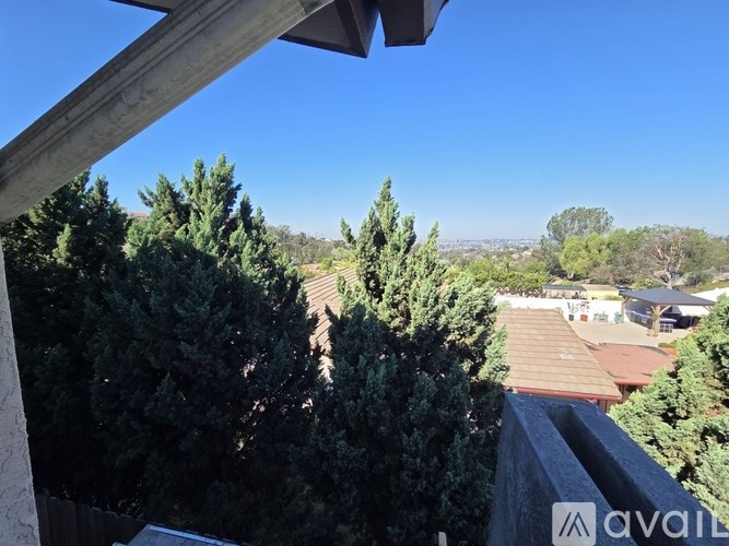 A view from a balcony overlooking a residential area.