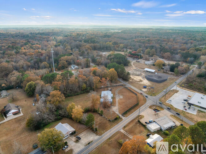 An aerial view of a suburban area with a mix of trees and buildings.