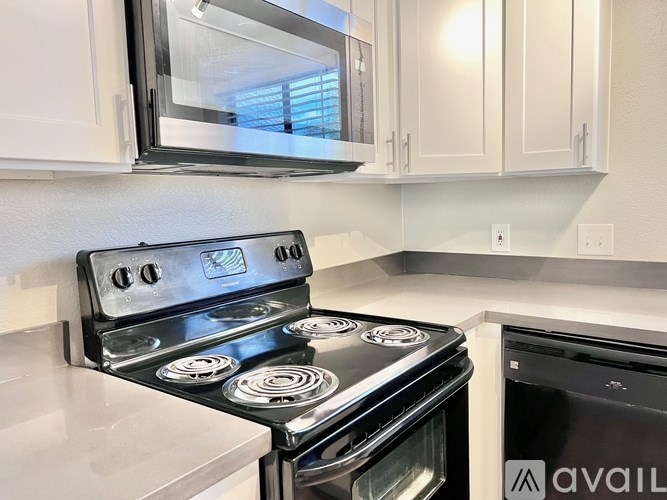 A modern kitchen with a stove and microwave.