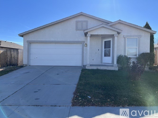 A two-story house with a garage is for sale.