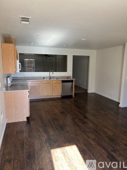 A kitchen with wooden floors and cabinets is available for rent.