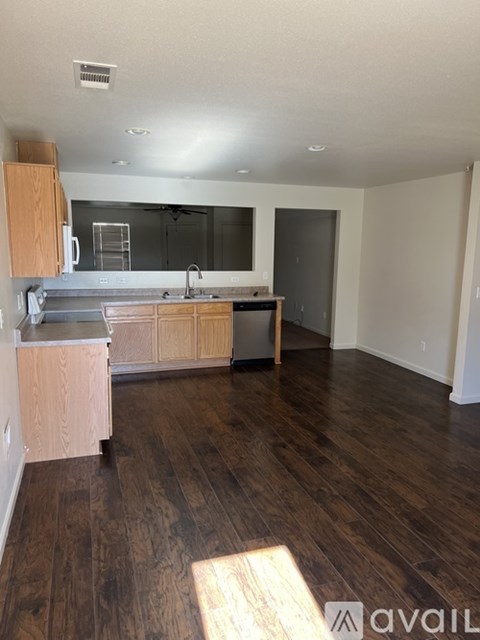 A kitchen with wooden floors and cabinets is available for rent.