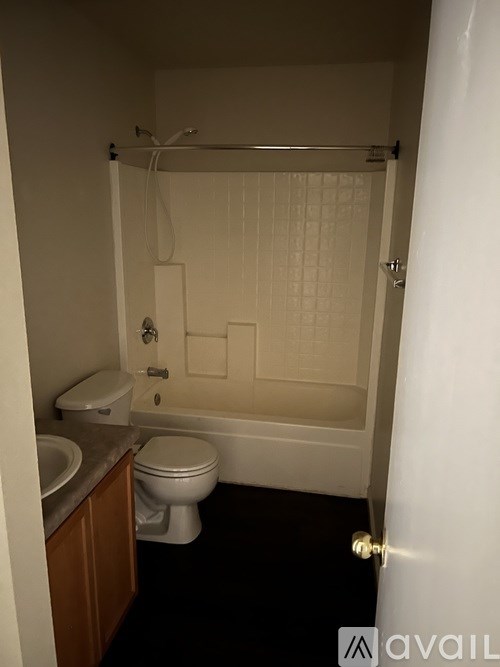 A small bathroom with a toilet, sink and bathtub.