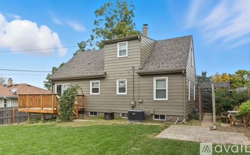 A house with a grey exterior and a brown deck.