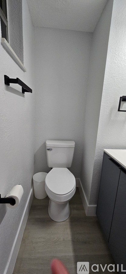 A white toilet in a small bathroom.