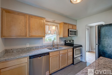 A kitchen with wooden cabinets and stainless steel appliances.