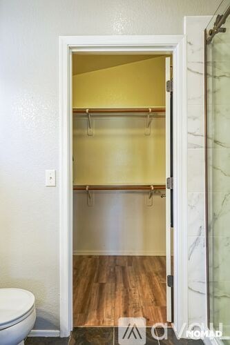 A white door with a glass panel and a wooden floor.