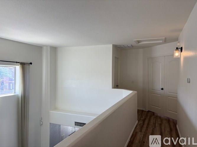 A white room with a window and a door.