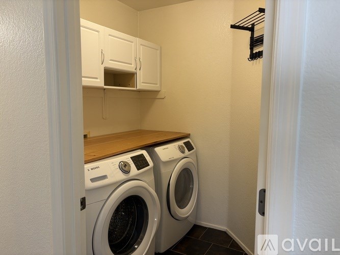 A small laundry room with a washer and dryer.