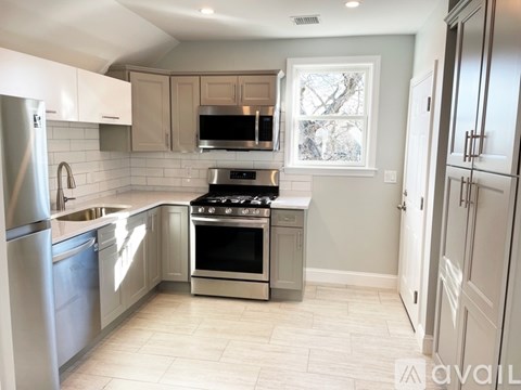 A kitchen with a stove top oven and a microwave above the stove.