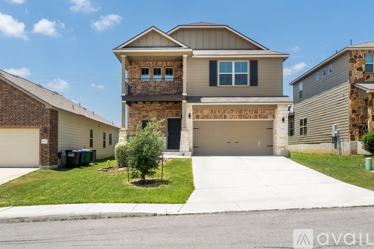 A two-story house with a garage is available for sale.