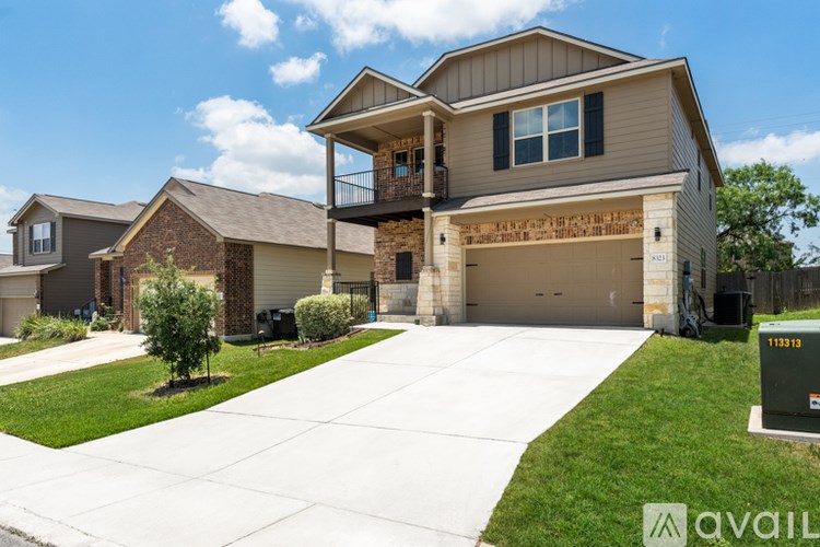 A large house with a garage and a driveway in front.