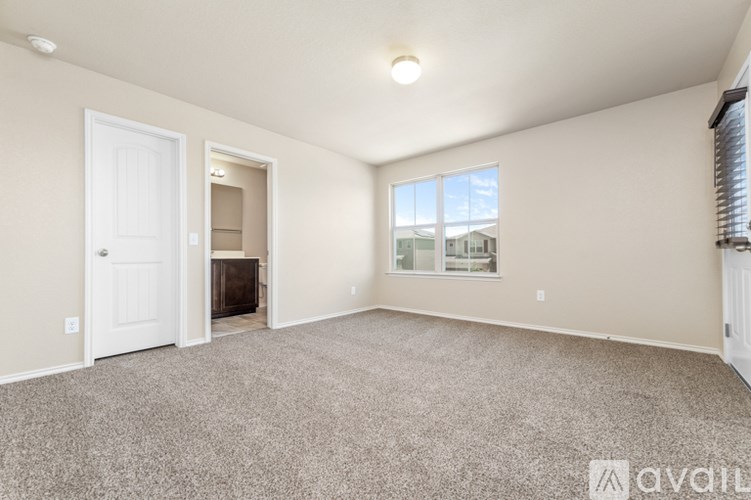 A spacious room with a carpeted floor and a fireplace.