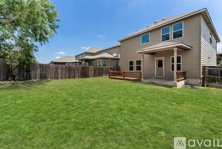A house with a fenced backyard is for sale.