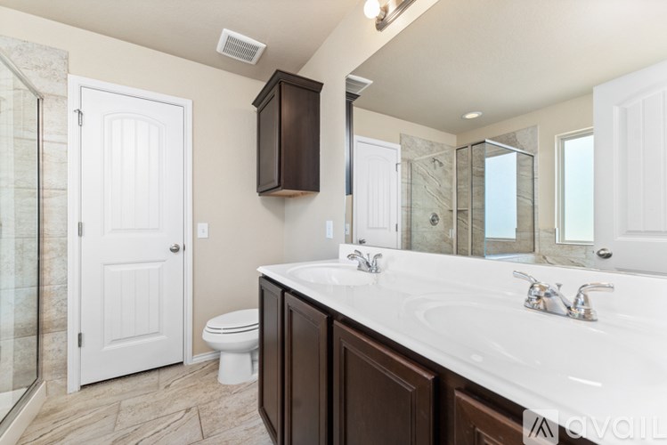 A bathroom with a white counter top and a white toilet.