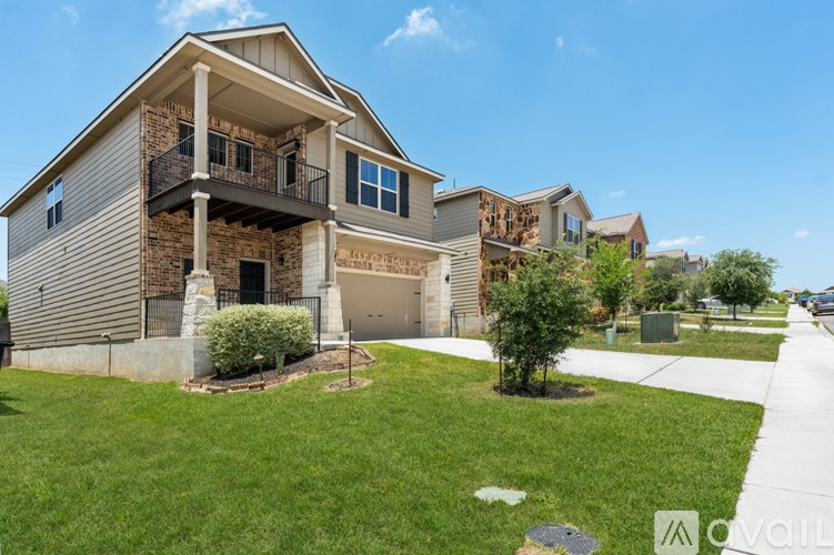 A house with a balcony and a garage is for sale.
