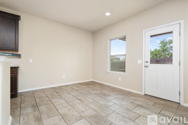 A room with a tiled floor and a door leading outside.