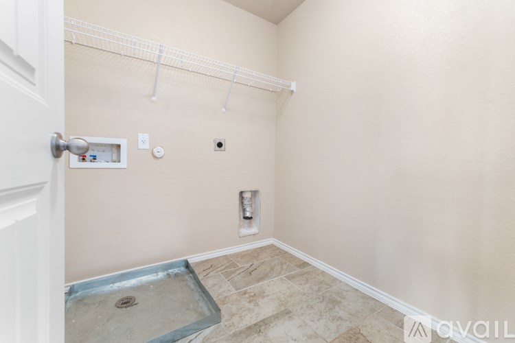 A bathroom with a walk-in shower and a white door.