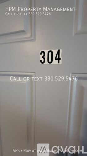 A door with a number 304 on it and a sign that says HPM Property Management.