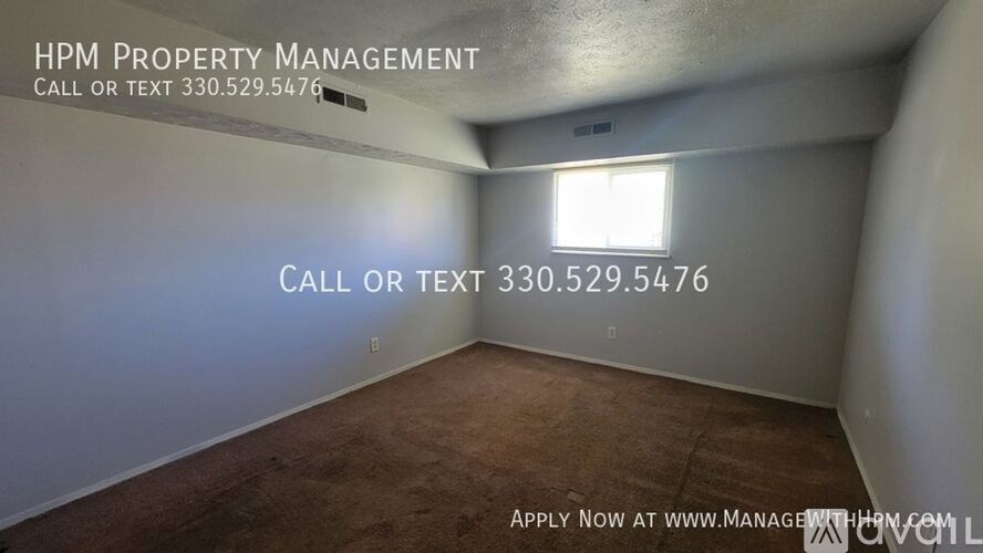 A room with HPM Property Management written on the wall and a phone number to call or text.