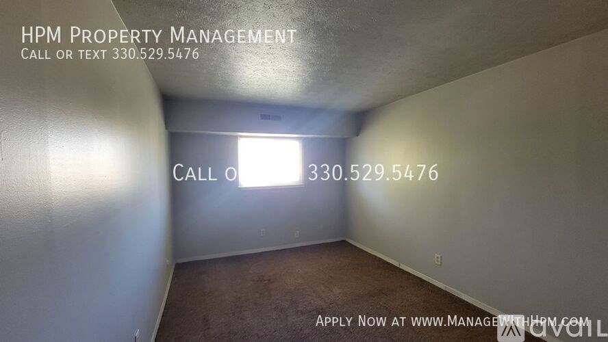 A room with a window and a sign for HPM Property Management.