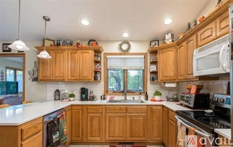 A kitchen with wooden cabinets and a white countertop.