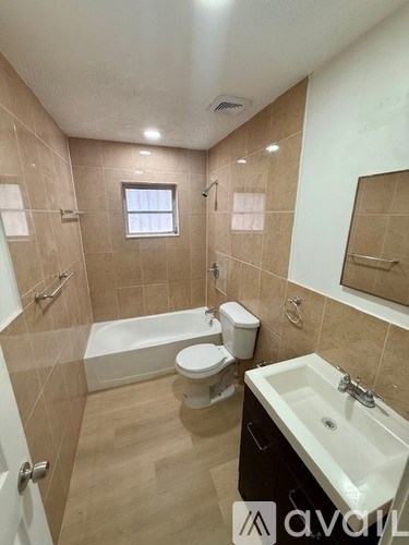 A bathroom with a toilet, sink, and bathtub.