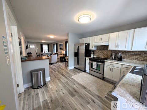 A kitchen with a refrigerator, stove, and oven.