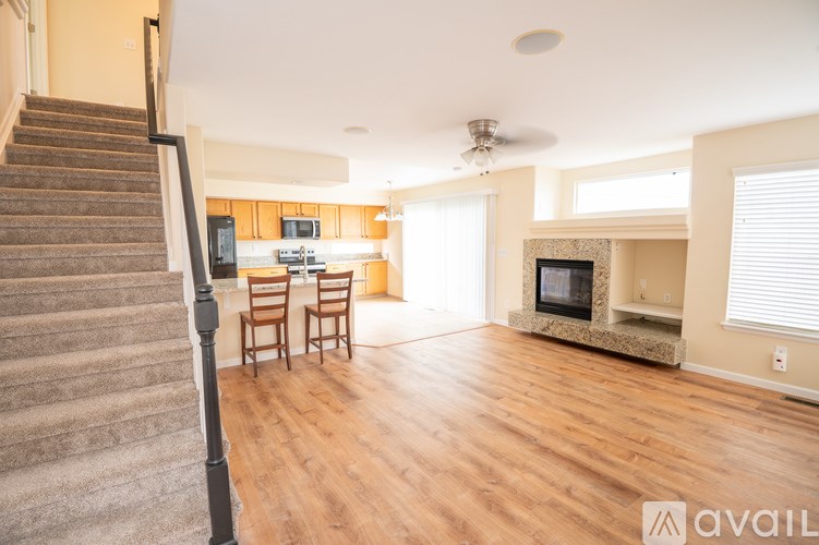 A living room with a staircase on the left side.