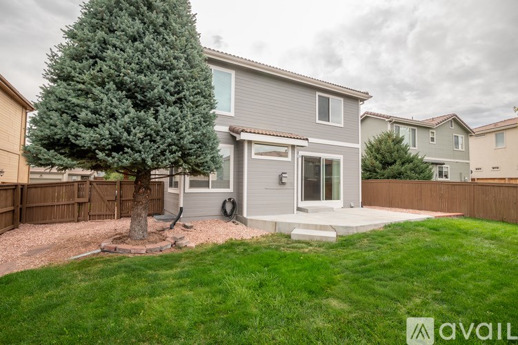 A house with a tree in front of it.