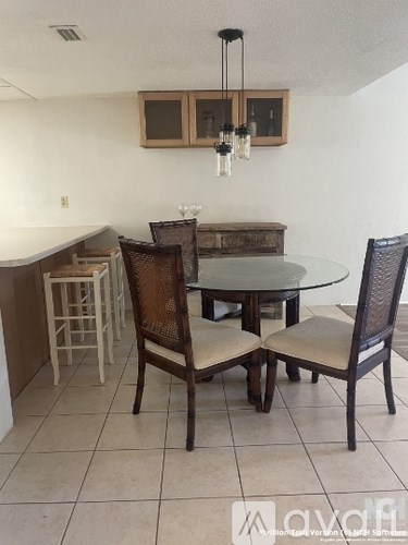 A dining room with a glass table and chairs.