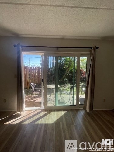 A room with a sliding glass door leading to a backyard.
