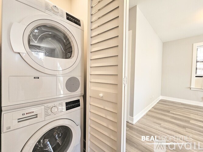 A white washing machine and dryer in a small laundry room.