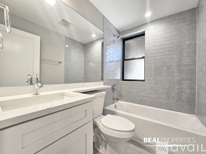 A modern bathroom with a white toilet and a white bathtub.