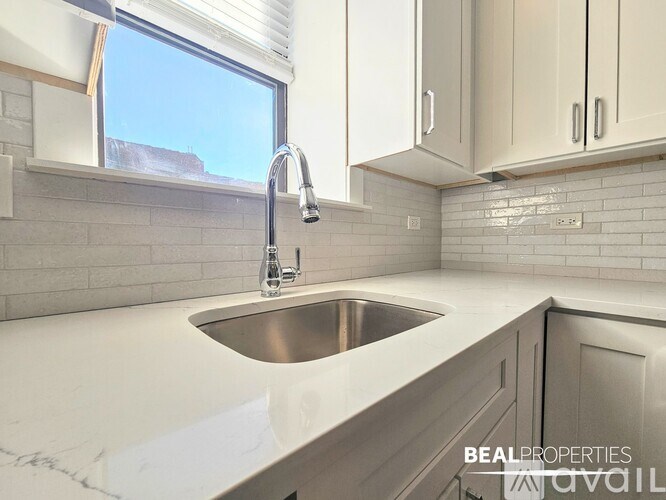 A modern kitchen with a sink and a window.